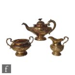 A William IV hallmarked silver pedestal tea set with embossed and engraved foliate decoration to