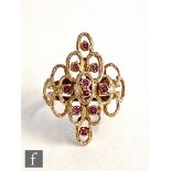 A 1970's 9ct hallmarked ruby ring set with ten stones to an open oval link design and split