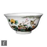 A Chinese famille rose bowl, Qianlong (1736-95) seal mark, but later, the white glazed footed bowl