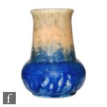 A small Ruskin Pottery crystalline glaze vase of globe and shaft form decorated in an orange to blue