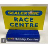 Two point of sale display signs, a Revell Hobby Center illuminated sign with printed perspex front