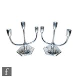 A pair of hallmarked silver three light candelabra, hexagonal bases with stepped centre below