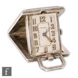 An Art Deco silver folding travel watch, gilt Arabic numerals to white rectangular dial within an