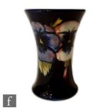 A small Moorcroft vase of flared form decorated in the Pansy pattern, impressed signature mark and