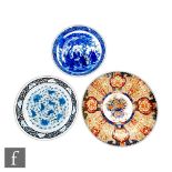 A collection of three Japanese porcelain chargers, to include a flowerhead shaped Imari example,