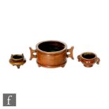 A collection of Chinese bronze censers, the two smaller of bombe form flanked with elephant and rope