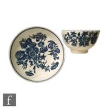 An 18th Century Caughley tea bowl and saucer decorated in the Three Flowers pattern in under glaze
