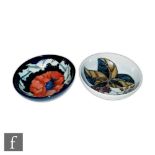 Two Moorcroft Pottery footed bowls, the first decorated in the Bramble pattern designed by Sally