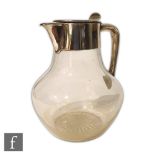 A Victorian hallmarked silver and clear glass claret jug, squat bulbous glass body below plain