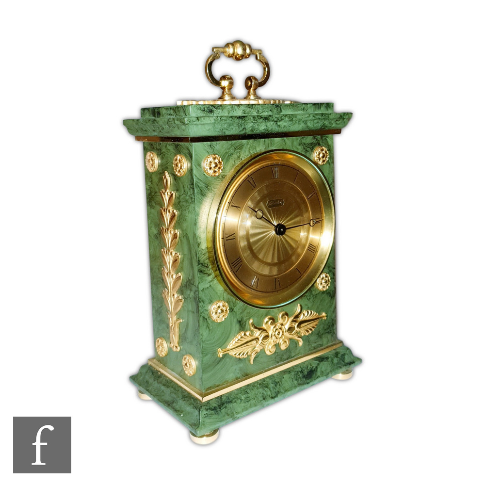 A replica French Empire style Le Castel mantle clock with gilt metal mounts in green figured case on