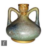 Unknown - An early 20th Century Art Nouveau twin handled vase decorated in an all over mottled green
