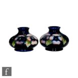 William Moorcroft - Pansy - A pair of compressed form vases circa 1912, decorated with flowers and