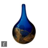 Mdina - A glass vase of compressed bottle form with gold leaf over the blue ground, engraved