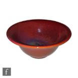 Pilkingtons Royal Lancastrian - A 1950s hand thrown bowl decorated in an all over ruby lustre