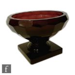 Moser - An early 20th Century deep amethyst glass bowl with a square pedestal foot, compressed