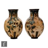 Edith Lupton - Doulton Lambeth - A pair of late 19th Century vases each decorated with carved bell