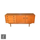 Unknown - A teak sideboard fitted with an arrangement of four drawers and a double door cupboard,