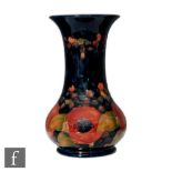 William Moorcroft - Pomegranate - A vase of globe and flared shaft form, decorated with a band of