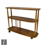 Lucian Ercolani for Ercol Furniture - A model 361 blonde elm and beech trolley bookcase, the three