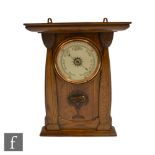 Shapland & Petter - An Arts and Crafts oak cased aneroid wall barometer, carved with stylised seed