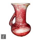 Ruskin Pottery - A high fired flower jug with angular handle and slight lip to the rim, the whole in