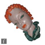 Goldscheider - A 1930s Art Deco wall mask modelled as a female head in profile with orange curled