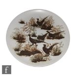 Nils Thorsson - Royal Copenhagen - A large Aluminia Faience charger decorated with grouse and