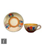 Clarice Cliff - Crocus - A Globe shape teacup and saucer circa 1930, hand painted with crocus sprays