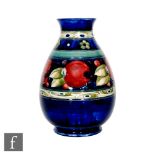 William Moorcroft - Banded Pomegranate - A vase of ovoid form with everted rim circa 1930, decorated