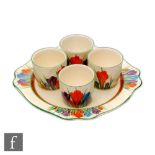 Clarice Cliff - Crocus - An egg cup set circa 1931 comprising a Leda shape plate with four matched