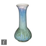 Ruskin Pottery - A high fired vase of conical globe and shaft form decorated with a mottled purple