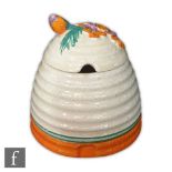 Clarice Cliff - Marguerite - A Beehive honey pot and cover circa 1933, with a floral relief