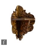 Unknown - An Arts and Crafts oak corner wall bracket with foliate carved detail, height 52cm and
