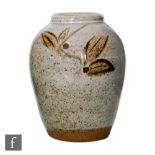 Alan Brough - A contemporary studio pottery vase decorated with sprigs of foliage over a mottled