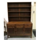 Attributed to Paul Matt for Brynmawr Furniture Makers - An oak dresser, the three-tier upper plate