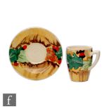Clarice Cliff - Acorn - A Lynton cup and saucer circa 1934, hand painted with stylised oak leaves