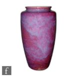 Ruskin Pottery - A high fired barrel vase with squat collar neck decorated in an all over mottled