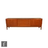 Jakobsen - A Danish Long Tom style teak sideboard, fitted with a central bank of four drawers