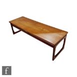 A teak G-Plan occasional coffee table of rectangular form, raised to loop shaped end supports,