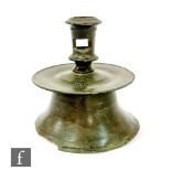 A Tudor period medieval bronze circular candlestick, circa 1450 - 1600,