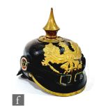 A World War One German pickelhaube, black leather and later chin strap, Koneg plate, height 24cm.