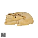 A late 18th/early 19th Century Japanese ivory netsuke modelled as a recumbent deer, unsigned, height