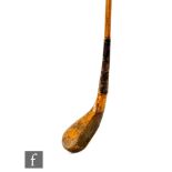A 19th Century hickory shafted golf putter, stamped R Forgan, length 108cm.