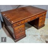 An Edwardian mahogany partners desk fitted with three drawers below a plain top