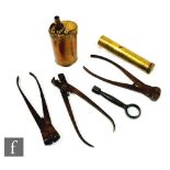 A small 19th Century copper and brass powder flask, a brass oil container, a lock key and three