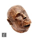 An African Makonde style helmet mask, possibly Mozambique or Tanzania, carved male face with light