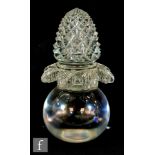 A 19th Century clear crystal desk weight of spherical form rising to an ornate pineapple finial