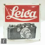 A vintage enamel Leica camera advertising sign, possibly 1930s/40s, the convex curved sign with