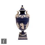 A later 20th Century Wedgwood Jasperware Dancing Hours vase and cover decorated in relief with
