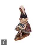 A large Lladro figure of a seated lady in traditional dress holding a piece of lace, printed mark,